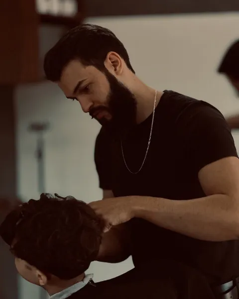 Barbeiro Tiago Hunziker cortando o cabelo de um cliente